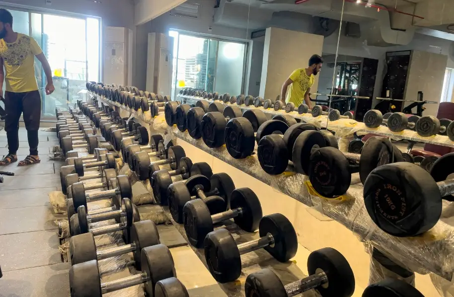 long matel stands that are holding high waight dumbles with the large mirrors on the front